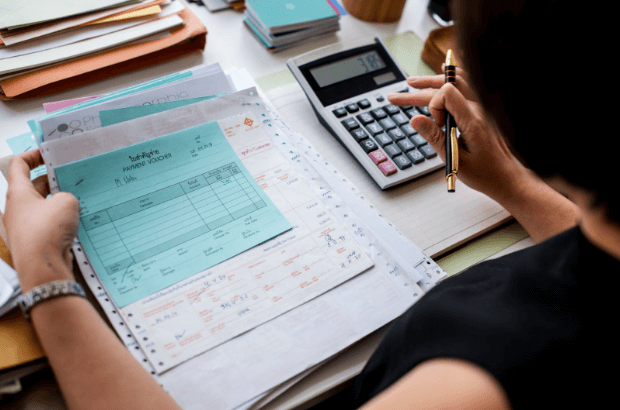 woman holding financial statements and invoices