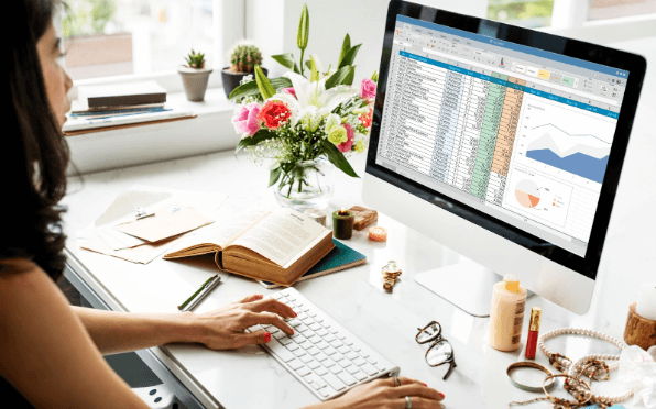 a woman analysing a spreadsheet on the computer