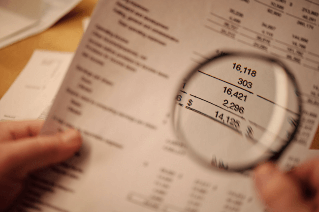 Understanding Different Accounting Types: A Beginner's Guide 2 magnifying glass on a financial report