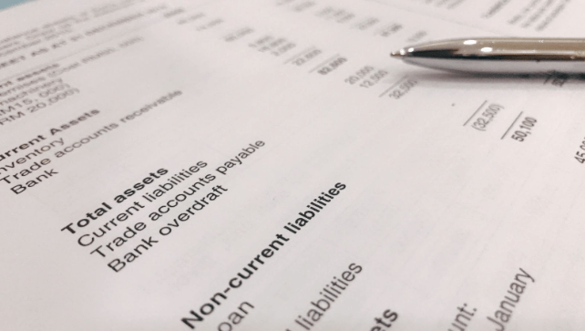 Understanding Different Accounting Types: A Beginner's Guide 1 financial report with a pen on top